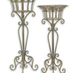 A PAIR OF IRON PLANTERS ON STAND